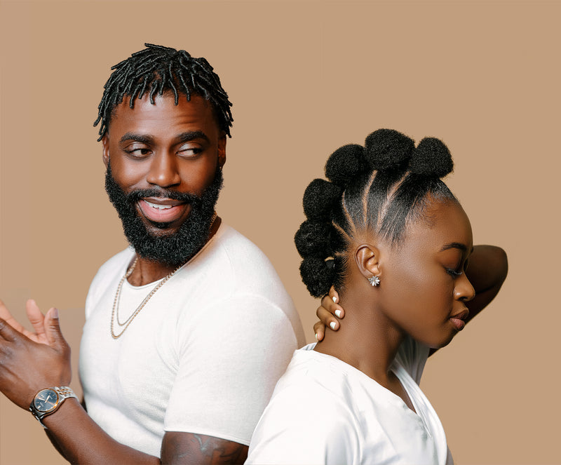 A smiling man with locs and a woman with a bantu-knot style